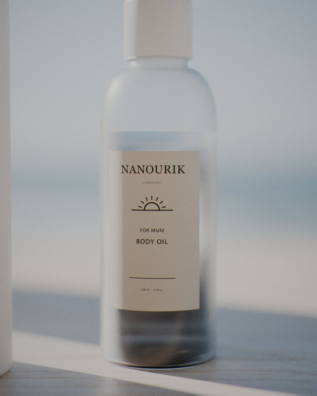 Nanourik body oil in a frosted bottle with a cream label